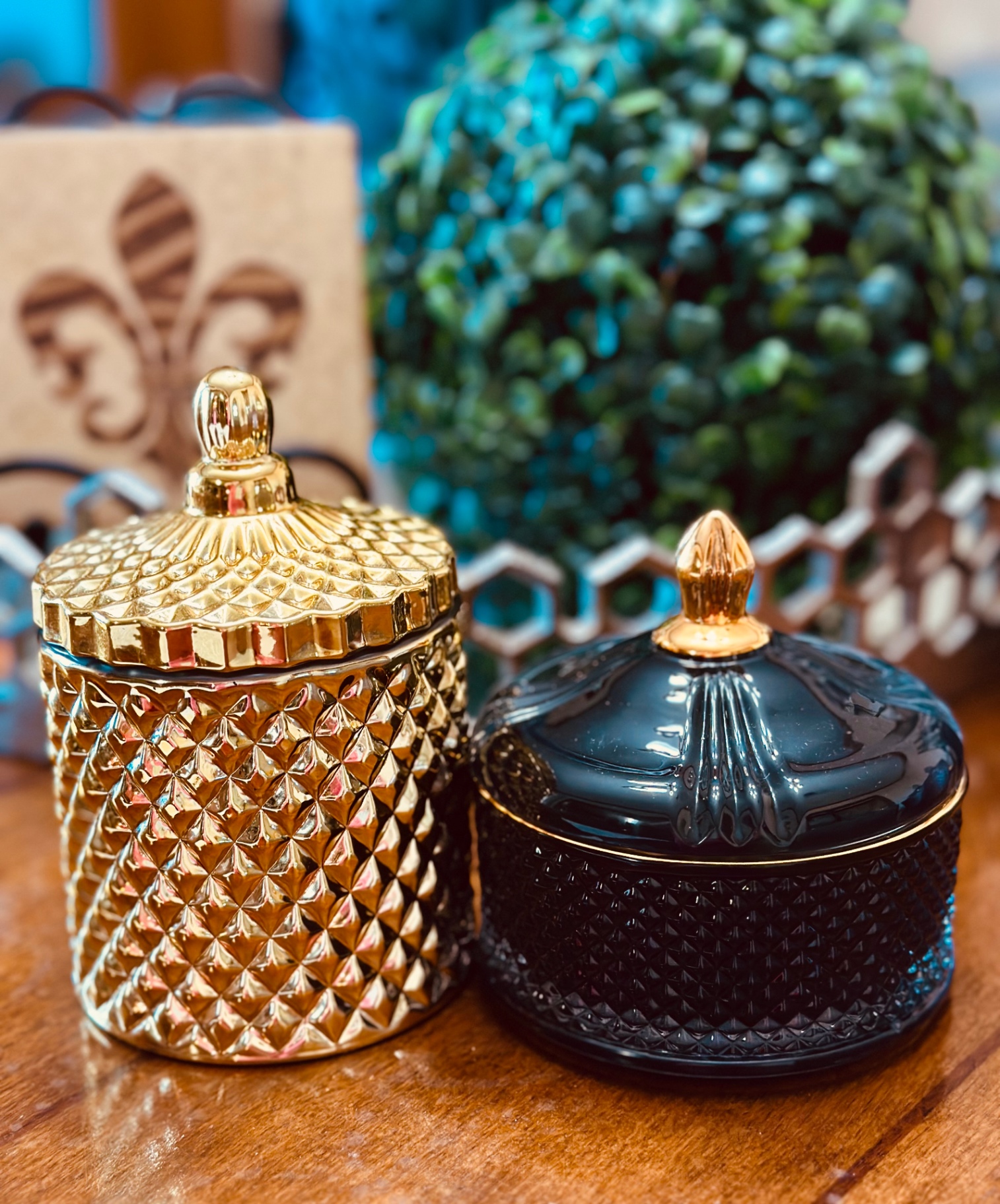 Gold and black faceted candle vessels with gold lid finials